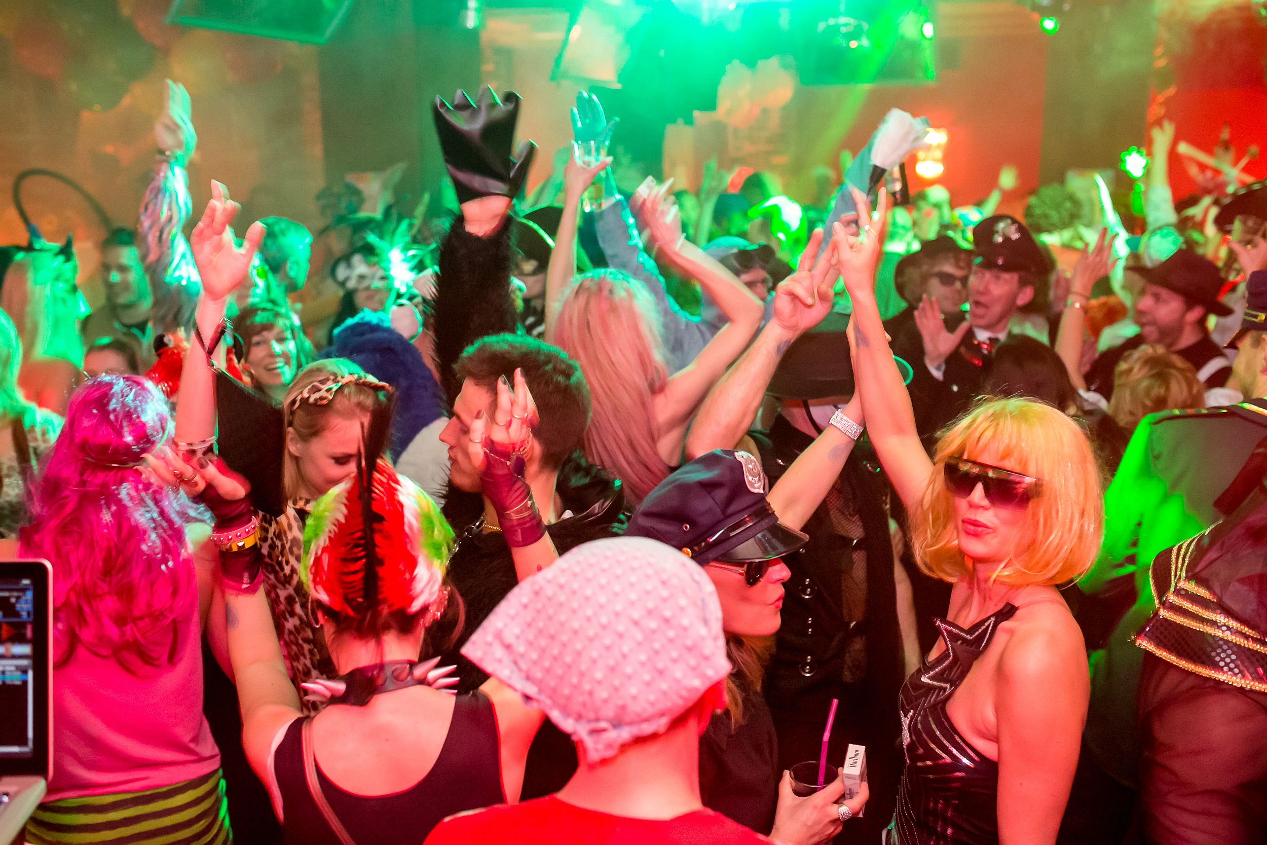  Crowd of people dressed in costumes dance on the dance floor at the Pichmännel carnival